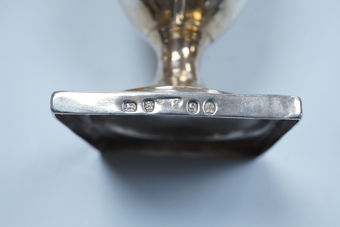 A George III silver cream jug, of oval form, London, 1801, 11cm, a George III silver helmet shaped cream jug, London, 1793, a George III small silver sugar pail, London, 1799 and a George V silver 'whisky' label, 8.4oz.